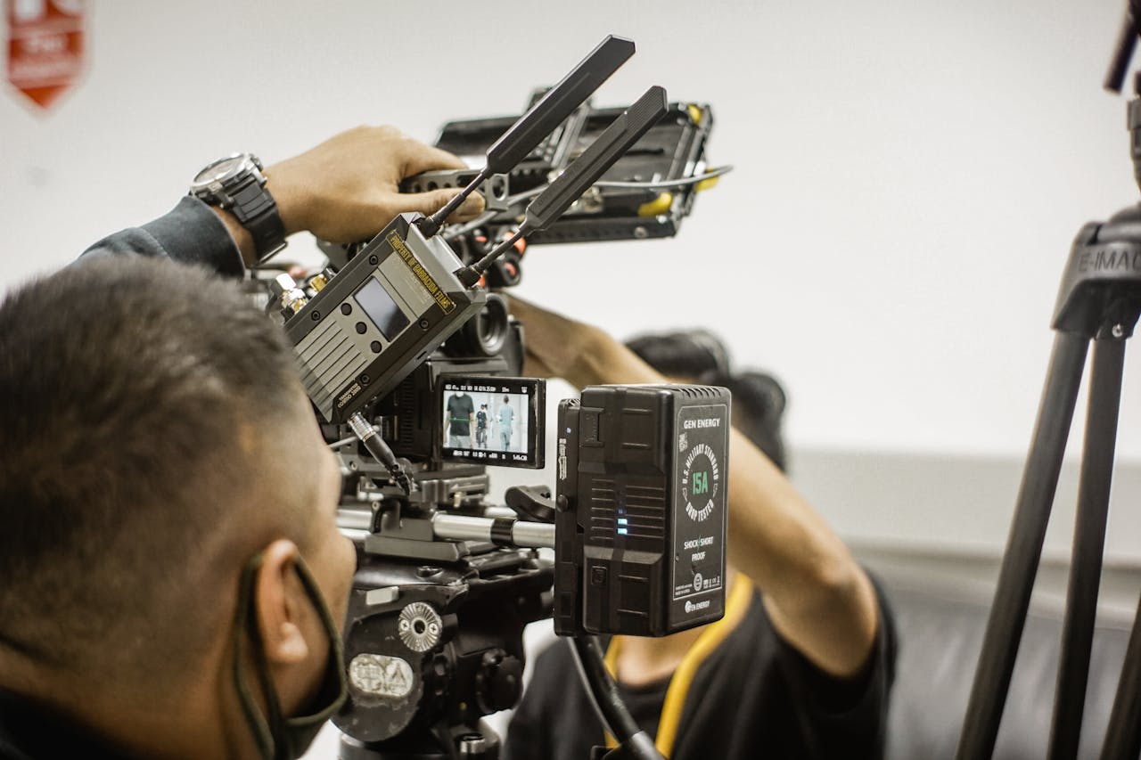 services-01 Close-up of advanced filmmaking equipment being used by professionals indoors.